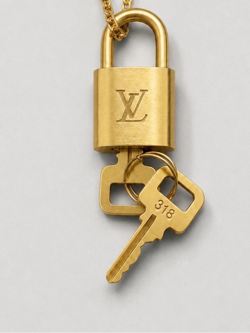 Louis Vuitton Gold Padlock Pendant with a Key
